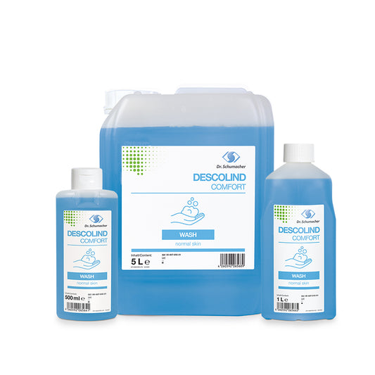 Abgebildet sind drei Flaschen der Dr. Schumacher GmbH DESCOLIND COMFORT WASH in den Größen 500 ml, 1 L und 5 L (Kanister), jeweils mit blauer Flüssigkeit und weiß-blauen Etiketten. Der 5 L Kanister ist ein Auslaufartikel.