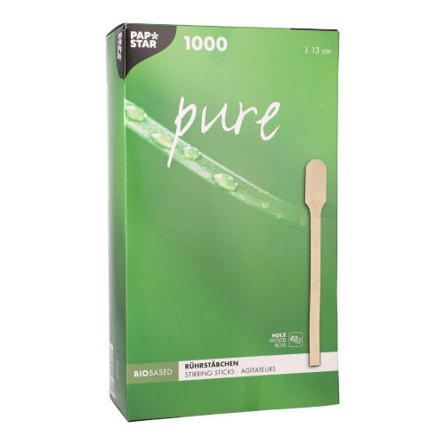 Ένα πράσινο PAPSTAR κουτί "pure" της PAPSTAR GmbH με 1000 αναδευτήρες χωρίς θραύσματα, φυσικά ελαφρείς 13 cm από ξύλο, είναι εξοπλισμένο με φωτογραφία ενός μεμονωμένου αναδευτήρα και υποδεικνύει ότι το προϊόν είναι βιολογικό και κατασκευασμένο από ξύλο.