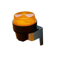 Μια προειδοποιητική λυχνία Swingo 2500/3500 της Diversey Deutschland GmbH & Co. OHG, με ριγωτό κεχριμπαρένιο κάλυμμα, τοποθετημένη σε μαύρη-ασημί βάση, απεικονίζεται σε λευκό φόντο.