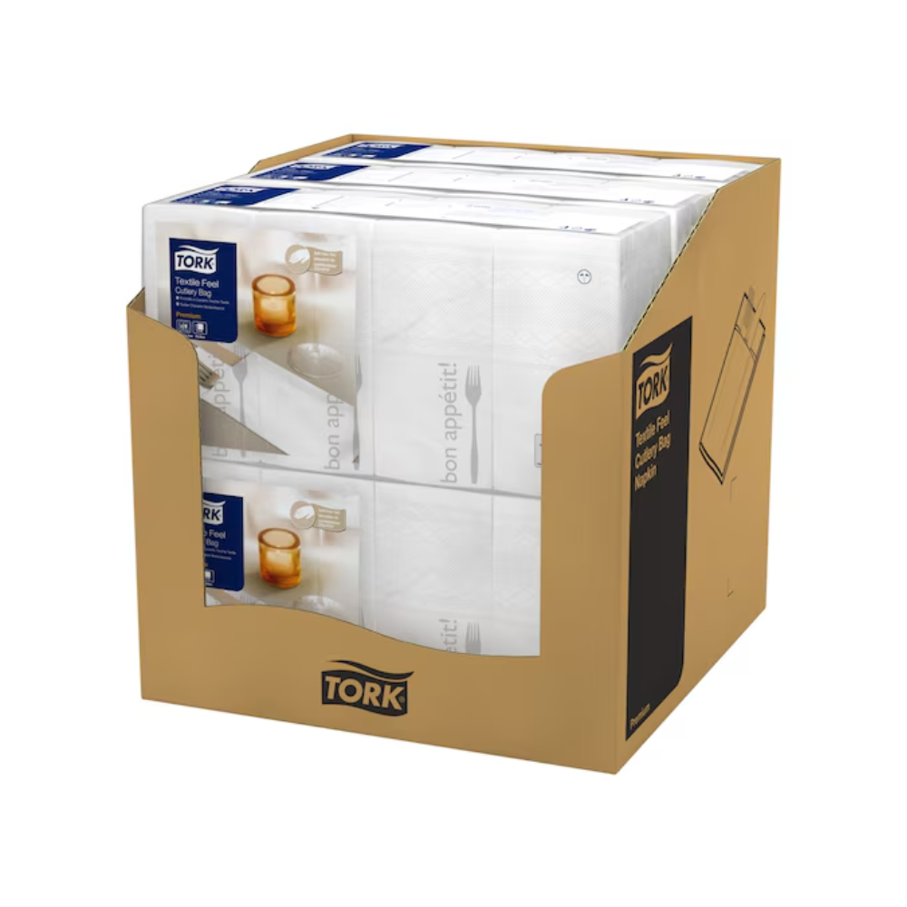 Ένα κουτί με έξι συσκευασίες Tork 13662 Tork Soft Guten Appetit Bestecktaschen-Servietten, καθεμία με μια μπλε ετικέτα. Η συσκευασία είναι διακοσμημένη με μια εικόνα μαχαιριού, πιρουνιού και ποτηριού καθώς και τη φράση «Καλή Όρεξη» και ενσωματώνει με κάθε προϊόν Tork Soft της Essity Professional Hygiene Germany GmbH την κομψότητα στο φαγητό.