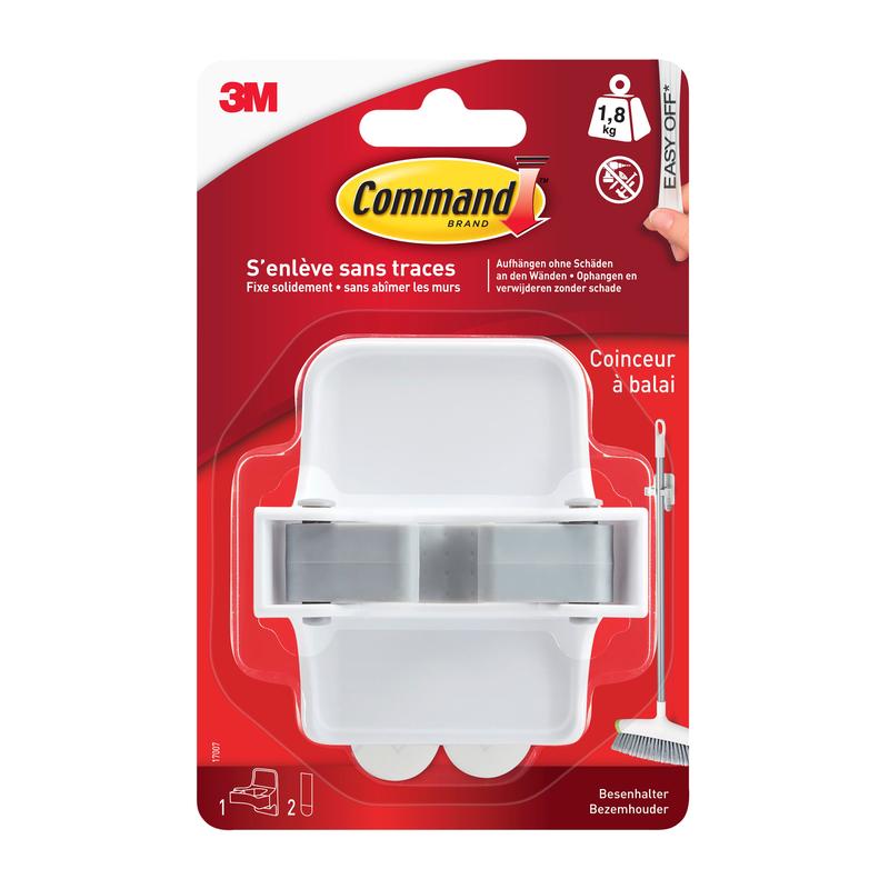 Ένας λευκός Command™ Βάση σκούπας 17007-FR από την 3M Deutschland GmbH σε πλαστική συσκευασία με κόκκινο φόντο, γαλλικό κείμενο, Command λωρίδες κόλλας και μια εικόνα σκούπας δίπλα στη βάση.